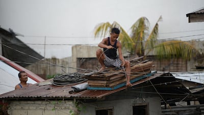 Residents secure the roof of their house as Typhoon Mangkhut approaches the city of Tuguegarao, Cagayan province, north of Manila. Ted Aljibe / AFP