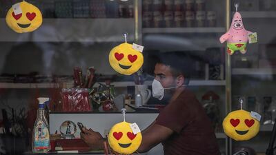 A shop owner wears a protective face mask in Gaza City. EPA