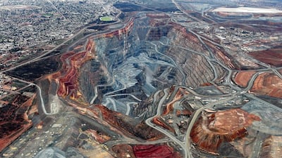 The township of Kalgoorlie, left, stands next to the Fimiston Open Pit mine in Australia. Rapid economic development and population growth is placing significant strain on the Earth’s natural resources. Carla Gottgens / Bloomberg