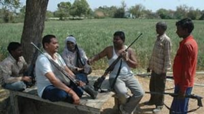 In parts of central India where abduction is high, people carry guns wherever they go. Men in Madhya Pradesh's Gwalior district sit with their weapons.