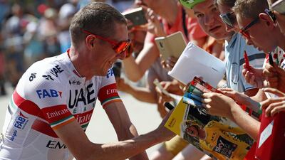 Dan Martin signs autographs for fans ahead of stage 5.