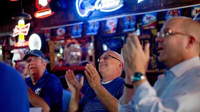 Bob Yarbrough, from left, George Szczepanik and Patrick Bell react to a catch as they watch the broadcast of Game 4 of the AL Championship Series between the Baltimore Orioles and the Kansas City Royals, in St. Joseph, Mo., Wednesday, Oct. 15, 2014. The Royals won 2-1 to sweep the series and advance to the World Series. AP Photo/St. Joseph News-Press, Sait Serkan Gurbuz
