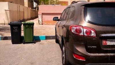 Rubbish bins block parking spaces in the neighbourhood southwest of 19th street and Airport road in Abu Dhabi.