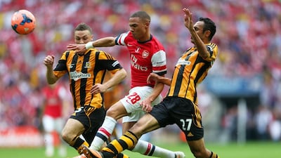 Kieran Gibbs of Arsenal takes on James Chester, left, and Ahmed Elmohamady of Hull City during the FA Cup final on Saturday. Paul Gilham / Getty Images / May 17, 2014