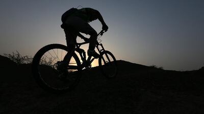The keenest mountain bikers in the UAE take to night-biking when temperatures rise in the UAE. Pawan Singh / The National