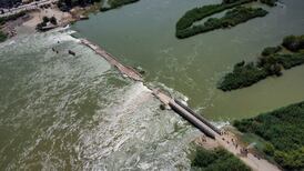 Water surges over an earthen bridge in Deir Ezzor, Syria. Photo: SANA