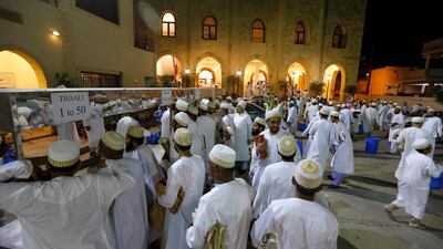 Pakistani Muslim families of Dawoodi Bohra Community gather to take free sack of food items distributed by their community's mosque ahead of Islamic fasting month of Ramadan, in Rawalpindi, Pakistan. AP