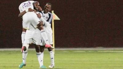Jires Kembo Ekoko, middle, is greeted by teammates after he scored the eventual game-winning goal late in the first half.