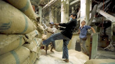 A rice mill worker pulls bags of rice in a mill in Udon Thani. Thailand was surpassed by India as the top exporter in 2014. Jorge Silva / Reuters