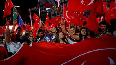 Turks shout slogans and wave national flags as they gather in solidarity after the July 15 coup attempt. Umit Bektas / Reuters