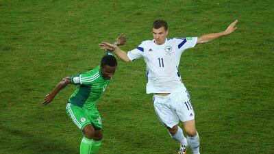 John Obi Mikel, left, of Nigeria, vies for the ball with Edin Dzeko, right, of Bosnia during their 2014 World Cup Group F match on Saturday in Cuiaba, Brazil. Clive Brunskill / Getty Images