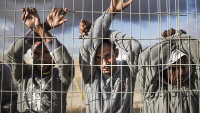 Asylum seekers protest on February 17, 2014, at the Holot detention centre, where hundreds of migrants are being held in the southern Negev desert of Israel. More than 50,000 illegal African migrants are seeking asylum after escaping war and government repression in their native lands. Ilia Yefimovich / Getty Images