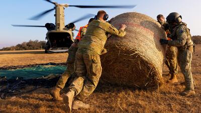Australian Army CH-47 Chinooks from the 5th Aviation Regiment deliver hay bales to remote bushfire-affected farms on Kangaroo Island, Australia. Reuters