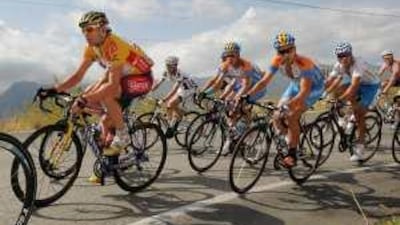 Cadel Evans, left, works his way through the peloton during the Tour of Spain.