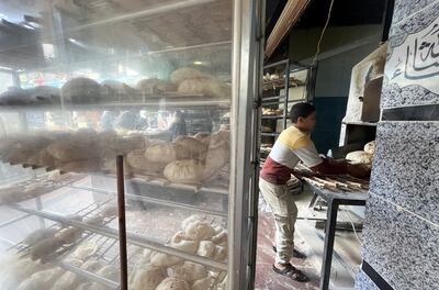A child prepares bread at a bakery in Cairo. Reuters