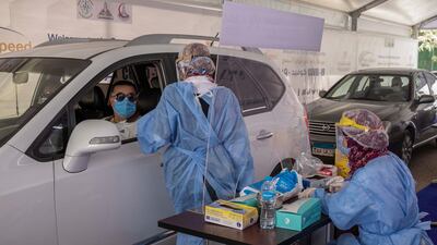 A motorist arrives for testing at a drive-through coronavirus screening centre in Cairo. AP Photo
