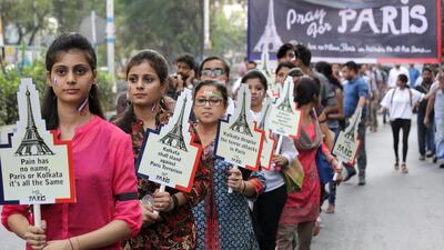 Young women take part in a march on Wednesday in the eastern Indian city of Kolkata to honour the victims of the terrorist attacks in Paris, which killed 129 people and left hundreds injured. Piyal Adhikary / EPA