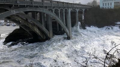 Heavy surf surrounds the legs of a bridge as an extreme high tide rolls into the harbor in Depoe Bay, Oregon during a so-called "king tide" that coincided with a big winter storm, January 11, 2020. AP Photo