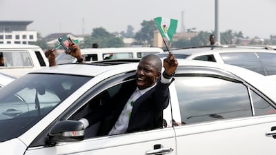 A demonstrator raises a Nigerian flag at the protest in Lagos. Reuters
