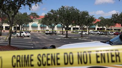 Palm Beach County Sheriff’s crime scene tape is seen outside of a Publix supermarket where a woman, child and a man were found shot to death in Royal Palm Beach, Florida. Law enforcement officials continue to investigate the crime scene for clues as to why the shooting occurred. Getty Images
