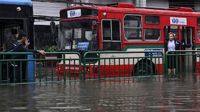 Buses are stranded in flood water in Bangkok. AFP