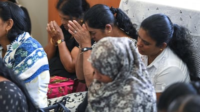 People pray at the multi-religious remembrance ceremony.