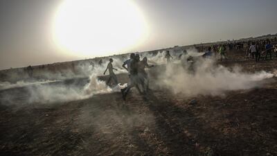 Palestinians protesters run for cover from Israeli tear gas during after a protest near the border in east Gaza City last week. EPA