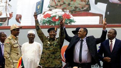 Sudan's Head of Transitional Military Council, Lieutenant General Abdel Fattah Al-Burhan, and Sudan's opposition alliance coalition's leader Ahmad Rabiah, celebrate the signing of the power-sharing deal, that paves the way for a transitional government, and eventual elections. Reuters
