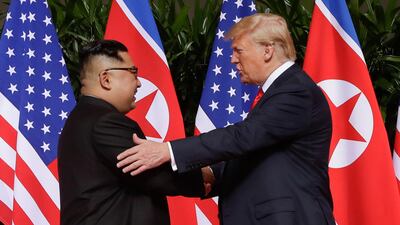 US President Donald Trump shakes hands with North Korean leader Kim Jong-un at the Capella resort on Sentosa Island in Singapore. AP