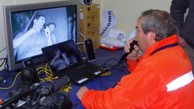 Andre Sougarret the head of the team of workers, talks via video conference with Mario Sepulveda, one of the 33 trapped miners, inside a camp outside the mine September 4, 2010. Rescue workers are preparing to begin using a Schramm T130 Drill, normally used to bore water wells, parallel to another slower one already working, in a bid to reach the miners stuck in a hot and humid tunnel 2,300 feet (700 meters) underground. REUTERS