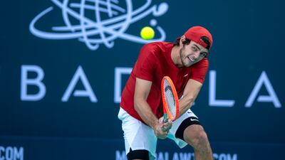 Taylor Fritz hits a backhand to Denis Shapovalov during their Mubadala World Tennis Championship quarter-final. Victor Besa / The National