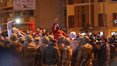 Lebanese army soldiers and riot police surround chanting supporters of the Shiite Hezbollah and Amal groups after clashes broke out with anti-government protesters in the capital Beirut. AFP