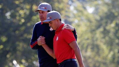 Rickie Fowler and Phil Mickelson of USA react after making a putt on the 16th green during morning foursome matches at the Ryder Cup. Jamie Squire / Getty Images / AFP