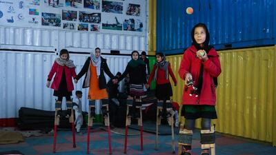 An Afghan girl juggles as she stands on stilts during a training at Mobile Mini Circus centre in Kabul, Afghanistan. EPA