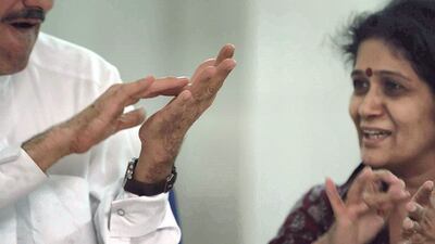 Vonita Singh shows finger movements inspired by dance to a Parkinson's patient at a Movement Mantra class