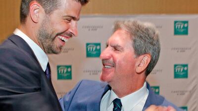 David Haggerty, right, celebrates with Gerard Pique during the ITF annual general meeting in Orlando. AFP