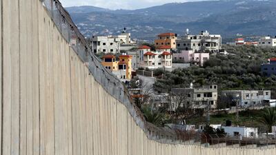 Buildings in the Palestinian village of Nazlat Isa near Tulkarm in the Israeli-occupied West Bank are seen behind the Israeli barrier and from the Arab-Israeli village of Baqa al-Gharbiyye on February 1, 2020. Reuters