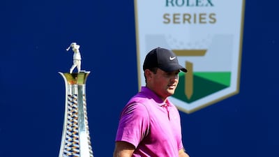 Patrick Reed walks past the Race to Dubai Trophy which the American will be lifting if he is victorious on Sunday. Getty