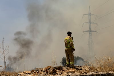 A firefighter inspects a fire that broke out as the result of a drone attack near the border with Lebanon in Northern Israel, Israel. Getty