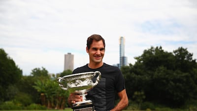 Roger Federer poses with the Australian Open trophy after winning the title on Sunday. Clive Brunskill / Getty Images
