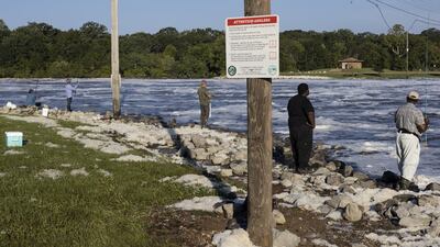 People fish in the Pearl River. AFP