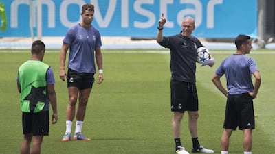 Zidane next to Cristiano Ronaldo, left, during the training session. Paul White / AP