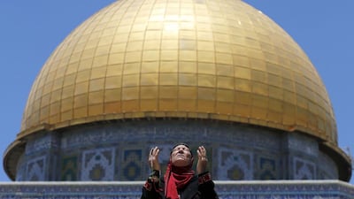 A woman prays in front of the Dome of the Rock in Jerusalem’s Old City on the first Friday of Ramadan on June 19, 2015. Ammar Awad / Reuters