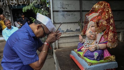An Indian devotee offers prayer to an idol of the elephant-headed Hindu God Ganesha, in Mumbai, India. EPA