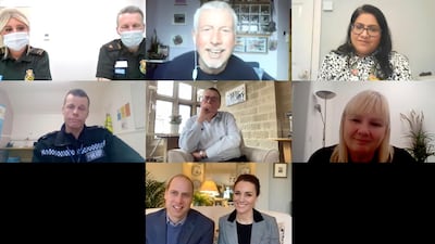 Britain's Prince William and his wife Kate, the Duchess of Cambridge, speak to frontline workers. AP