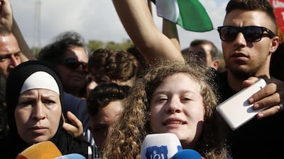 Ahed Tamimi was surrounded by reporters as she arrives at the West Bank village of Nabi Saleh, upon her release. AFP