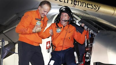 Bertrand Piccard, right, leaves Solar Impulse 2 at Al Bateen Airport to be greeted by his project co-founder and co-pilot Andre Borschberg on Tuesday. Peter Klaunzer / Keystone via AP Photo