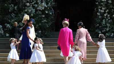 Kate, the Duchess of Cambridge, foreground left and Jessica Mulroney, in blue arrive with the bridesmaids for the wedding ceremony of Prince Harry and Meghan Markle. Pictured far right in light pink is Benita Litt, whose daughters count Meghan, now the Duchess of Sussex, as their godmother. AFP