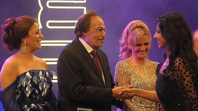 Egyptian actress Hanan Mutawe shakes hands with veteran Egyptian actor Ezzat Al Alaili while film stars Yusra, second right, and Nermin al-Feqi look on during the opening ceremony of the 32nd Alexandria film festival in Egypt's northern coastal city of Alexandria on September 21, 2016. AFP