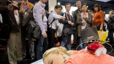 A crowd watches a demonstration of a Whee robotic massager at the Consumer Electronics Show in Las Vegas this month. Julie Jacobson / AP Photo